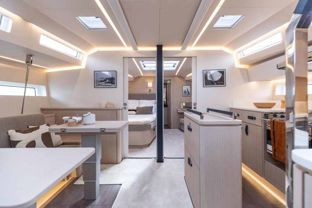 jeanneau 55 interior showing lounge area, kitchen, and bed