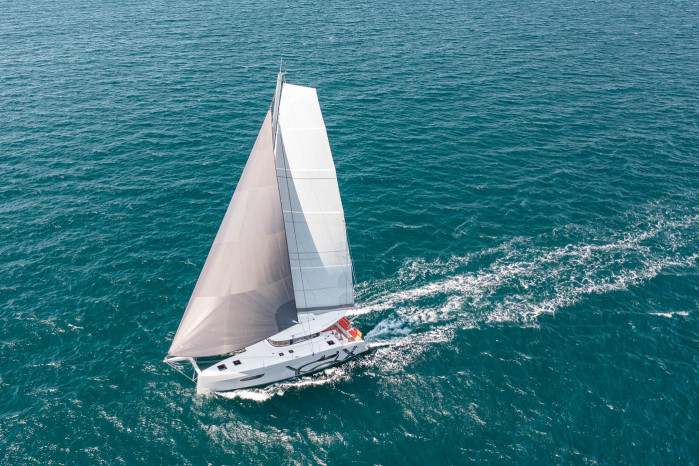 excess 14 with white hull and sail on open water