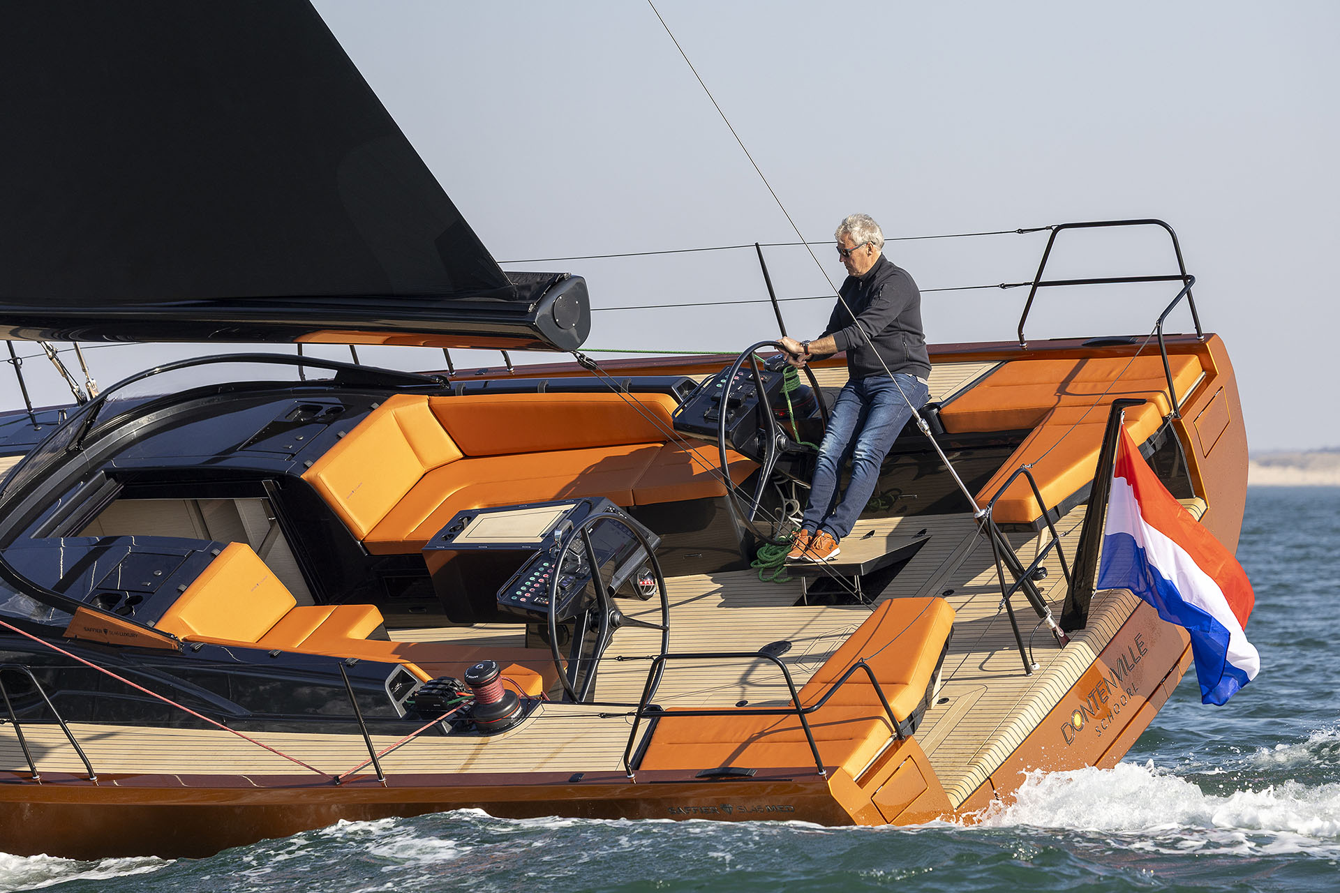 A person sailing a Saffier SL46 MED with orange hull and grey sails. © Sander van der Borch